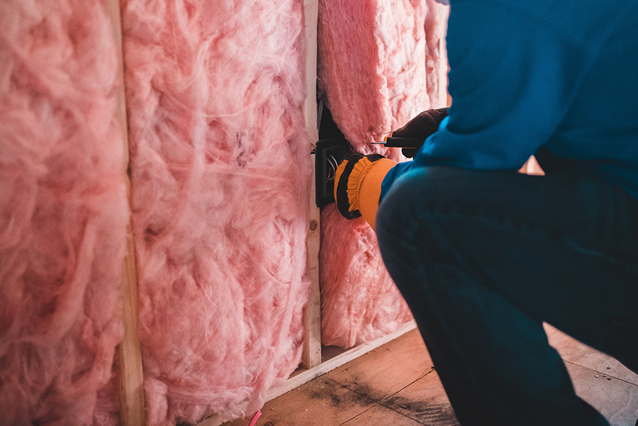 Man installing new wall insulation
